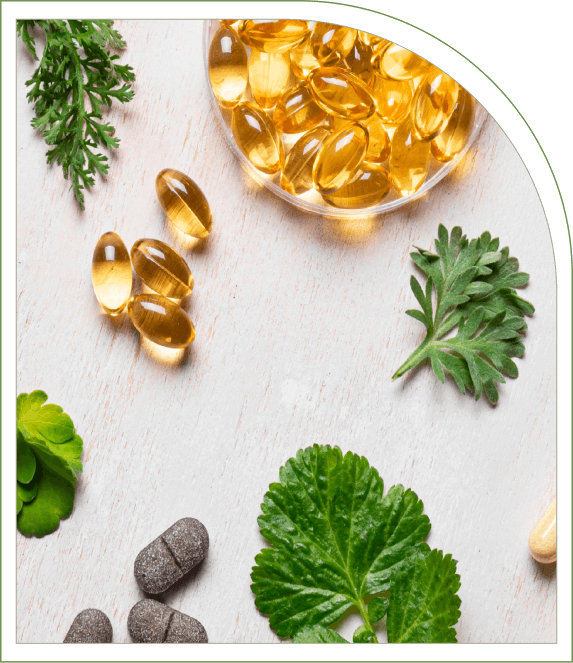 Capsules and tablets on a table with parsley and other herbs.