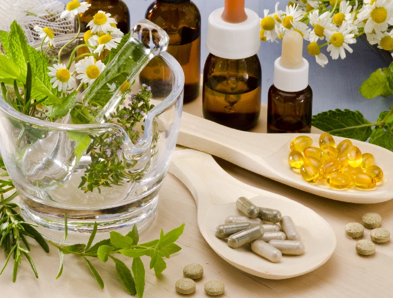 A table with some herbs and pills on it